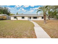 Charming single-story home featuring a well-maintained lawn and inviting walkway at 345 Overstreet Ave, Longwood, FL 32750