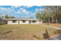 Single-story home with a light colored exterior and well-manicured lawn at 345 Overstreet Ave, Longwood, FL 32750