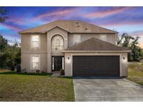 Two-story home features an attached two car garage and well maintained lawn at 2645 Coachman Dr, Deltona, FL 32738