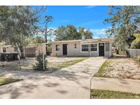 Charming single-story home with a well-maintained front yard and a long driveway at 906 Ferndell Rd, Orlando, FL 32808