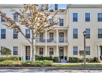 Charming three-story townhome with a private balcony and well-manicured landscaping at 1725 Prospect Ave, Orlando, FL 32814