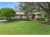 Charming home with mature landscaping and a well-manicured lawn at 1921 Redwood Grove, Lake Mary, FL 32746