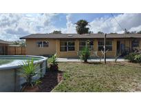 A home's backyard features an above-ground pool and multiple windows at 210 Dartmouth St, Deltona, FL 32725