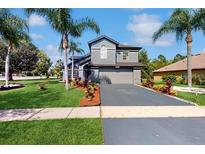 Charming two-story home with well-maintained landscaping and a paved driveway at 2405 Abalone Blvd, Orlando, FL 32833