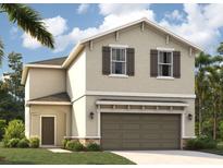 Charming two-story home featuring neutral stucco, brown shutters, arched entry, and an attached two-car garage at 3471 Salvia Ct, Tavares, FL 32778