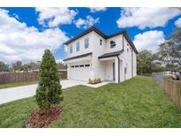 New two-story home features a two-car garage, manicured lawn, and modern architectural design at 39 N Sunset Dr, Casselberry, FL 32707