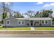 Charming single-story home featuring a well-manicured lawn and a freshly painted exterior at 4228 Lenox Blvd, Orlando, FL 32811