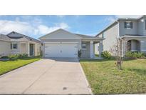 Charming one story home with a well manicured lawn and long driveway at 863 August Sky Dr, Deltona, FL 32738