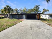 Charming single-story home featuring a spacious driveway and a modern, minimalist design at 214 Cherrywood Dr, Maitland, FL 32751