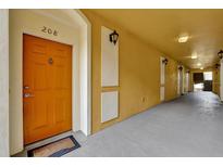 Condo hallway with door number 208, modern lighting, and freshly painted walls at 3338 Robert Trent Jones Dr # 20804, Orlando, FL 32835