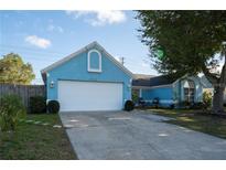 Charming single-Gathering home with a well-maintained lawn, white garage door and complementing light blue paint at 4523 Saddle Creek Pl, Orlando, FL 32829