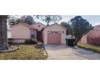 Charming single-story home featuring a well-maintained lawn and attached one car garage at 5436 Bayberry Homes Rd, Orlando, FL 32811