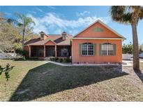 Charming home with a screened porch and lush landscaping at 1031 Kings Hwy, Kissimmee, FL 34744