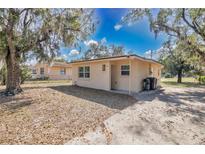 Charming single-story home featuring a well-maintained lawn and a cozy front entrance at 203 North E Blvd, Davenport, FL 33837