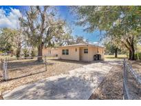 Cozy one-story home with a fenced yard and a concrete driveway, providing ample parking space at 203 North E Blvd, Davenport, FL 33837