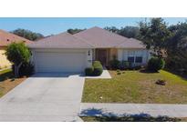 Charming single-story home boasts a well-manicured lawn, attached garage, and inviting curb appeal at 4175 Sw 46Th Ct, Ocala, FL 34474