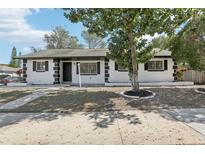 Charming single-story home with a beautifully landscaped front yard and mature tree at 4425 Signal Hill Rd, Orlando, FL 32808