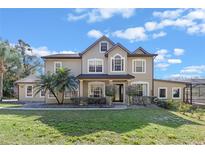 Stunning two-story home featuring mature palm trees and beautiful landscaping at 740 Hillcrest Ln, Altamonte Springs, FL 32701