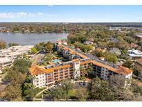 Stunning aerial view of the Cloisters complex, highlighting its lakeside location and terracotta tile roofs at 100 S Interlachen Ave # 111, Winter Park, FL 32789