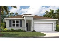Charming single-story home with a two-car garage, gray exterior, and well-maintained lawn at 1128 Clay Blvd, Tavares, FL 32778