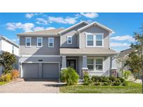 Charming two-story home with a well-manicured lawn, a two car garage and a welcoming front porch at 12027 Language Way, Orlando, FL 32832