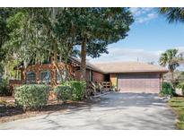 Charming single-Gathering home with a well-manicured yard, a covered porch, and an attached garage at 2929 Lakeshore Dr, Mount Dora, FL 32757