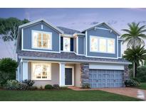 Charming two-story home featuring stone accents, a covered entryway, and a two-car garage at 726 Pointe Emerson Blvd, Apopka, FL 32703