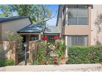 Inviting townhouse featuring well-maintained landscaping, a courtyard, and a charming exterior at 940 Douglas Ave # 132, Altamonte Springs, FL 32714