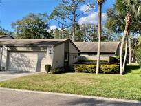 Charming home exterior with a one car garage and well-maintained landscaping at 1200 Winterberry Lane, Fern Park, FL 32730