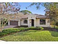 Charming single-story home with a well-maintained lawn, stucco facade, and a beautiful terracotta tile roof at 1690 Oneco Ave, Winter Park, FL 32789