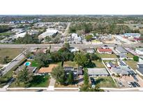 Neighborhood view of a single Gathering home with mature trees and a blue swimming pool at 1816 Jasper Drive, Orlando, FL 32807