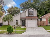 Charming two-story home features a well-maintained lawn and inviting front entrance at 1970 Larkwood Dr, Apopka, FL 32703