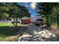 Charming single-story home with a driveway accommodating two vehicles and mature trees at 2413 Spingarn Ct, Orlando, FL 32811