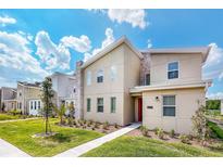 Modern two-story home featuring stone accents, a well-manicured lawn, and a vibrant blue sky at 2839 Bookmark Dr, Kissimmee, FL 34746