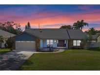 Charming single-story home featuring brick accents, a well-manicured lawn, and a two-car garage at 9532 Bay Vista Estates Blvd # 1, Orlando, FL 32836