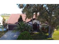 Charming single-story home featuring a well-maintained lawn, mature landscaping, and a two-car garage at 12017 Fambridge, Orlando, FL 32837