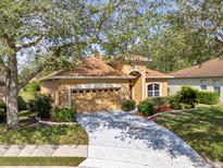Well-maintained home with lush landscaping, an attached two-car garage, and a concrete driveway at 1314 Chessington Cir, Lake Mary, FL 32746