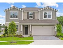 Charming two-story home featuring a two-car garage and beautifully landscaped front yard at 13154 Pergola Ave, Orlando, FL 32832
