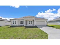 Charming single-story home with a well-manicured lawn and an attached two-car garage at 15240 Sw 43Rd Ct, Ocala, FL 34473