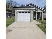 Charming single-Gathering home featuring a well-kept lawn and inviting front entrance, complete with a one-car garage at 1909 Bates Ave, Eustis, FL 32726