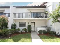 Charming townhouse featuring a private balcony, well-manicured lawn, and inviting front entrance at 350 Killarney Bay Ct # 5, Winter Park, FL 32789