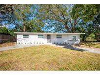 Charming single-story home with a fresh white painted brick and inviting landscaping in the front yard at 103 Ford Ave, Altamonte Springs, FL 32701