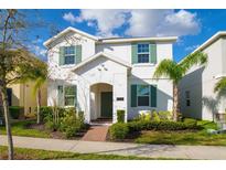 Charming two-story home features a well-manicured lawn and inviting front entrance with lush landscaping at 11157 Cyrilla Woods Dr, Orlando, FL 32832