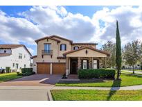 Charming two-story home with a well-manicured lawn and two-car garage at 15672 Shorebird Ln, Winter Garden, FL 34787