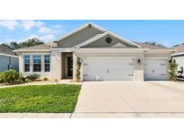 Charming single-story home with a well-manicured lawn and a two-car garage at 1598 Barberry Dr, Kissimmee, FL 34744