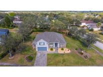 Inviting single-Gathering home featuring a well-manicured lawn and brick-paved driveway at 3978 Old Dunn Rd, Apopka, FL 32712
