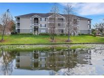 Apartment building featuring multiple stories, balconies, and a beautiful waterfront view at 4260 Summer Landing Dr # 202, Lakeland, FL 33810