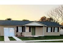 Charming single-story home featuring neutral paint, black shutters, and a well-maintained lawn at 106 Dahlia Dr, Kissimmee, FL 34743