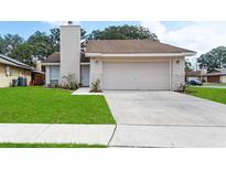 Charming home featuring a manicured lawn, driveway, and welcoming facade at 1188 La Mesa Ave, Winter Springs, FL 32708