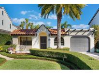 Charming single-story home featuring a red tile roof, mature landscaping, and an attached garage at 1585 Chestnut Ave, Winter Park, FL 32789